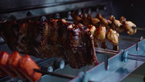 Variety-of-Meats-being-cooked-Rotisserie-style-in-restaurant-oven