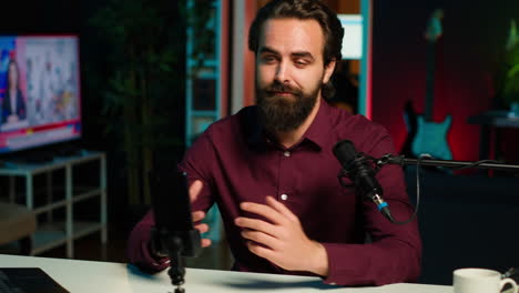 man using microphone and mobile phone to film asmr video