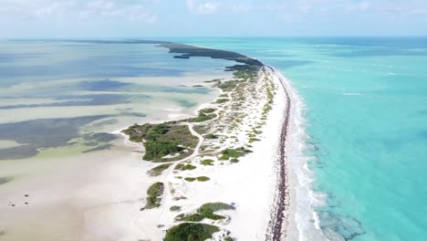 isla blanca or white island near cancún in mexico surrounded by shallow turquoise ocean waters