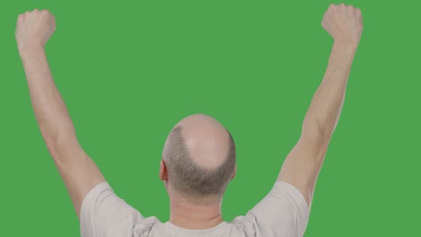 Successful bald man celebrating with hands up on keyed green screen. Alpha channel