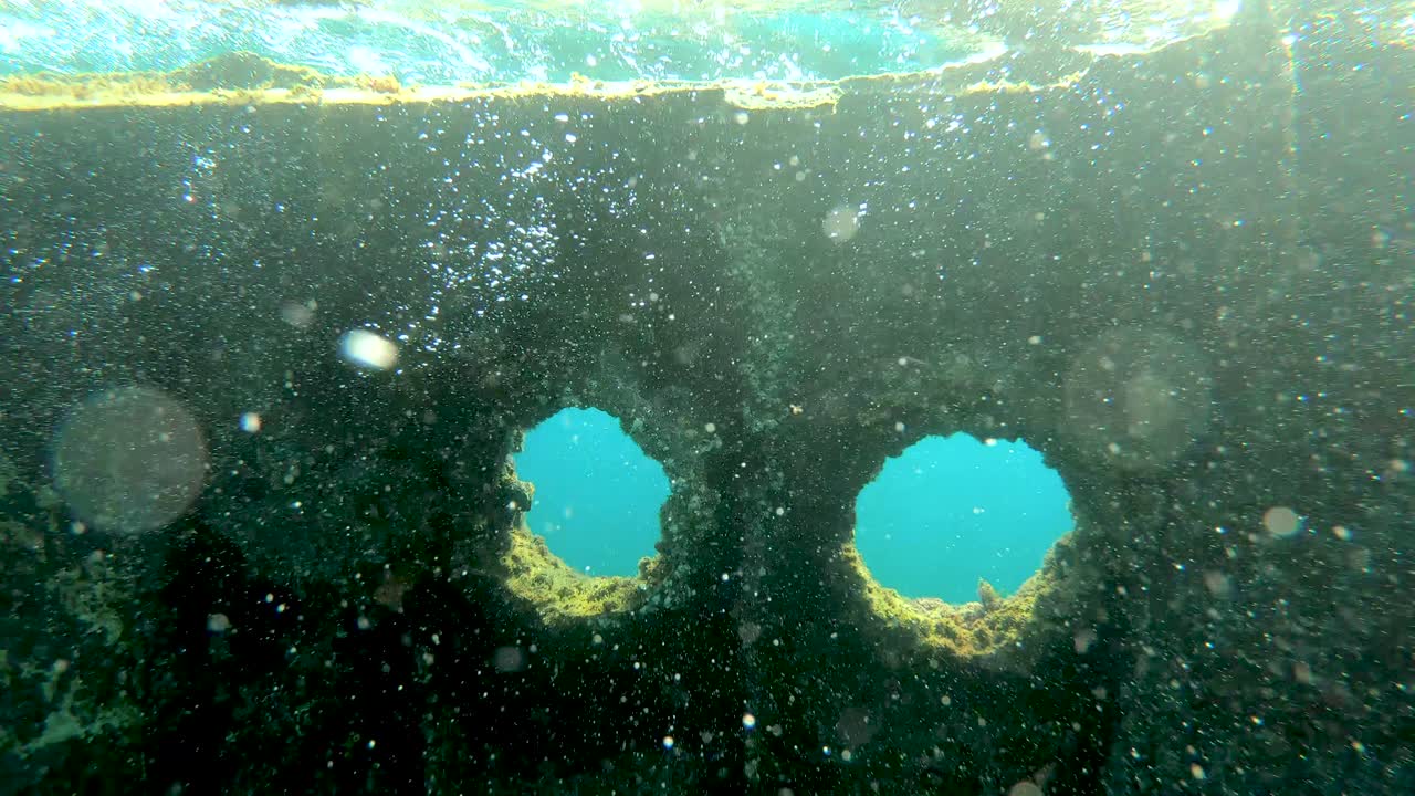 Shipwreck at seabed illuminated by sun rays