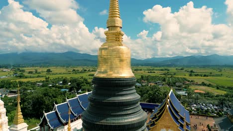 4k cinematic nature aerial drone footage of the beautiful temple of wat ban den next to chiang mai, thailand on a sunny day