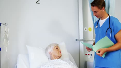 Doctor-interacting-with-a-patient-on-medical-bed-