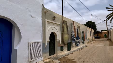 walking along colorful djerbahood street art location of djerba island in tunisia