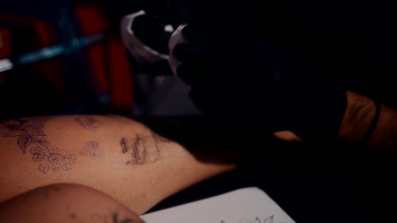 Tattoo artist taking a break from making client's tattoo