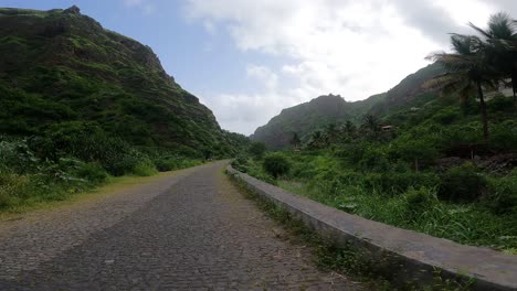 walking on paved pathway towards mountains in cape verde, africa