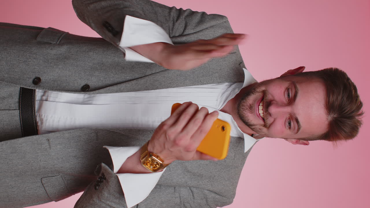 Happy business man use mobile phone say wow yes found out great big win news doing winner gesture