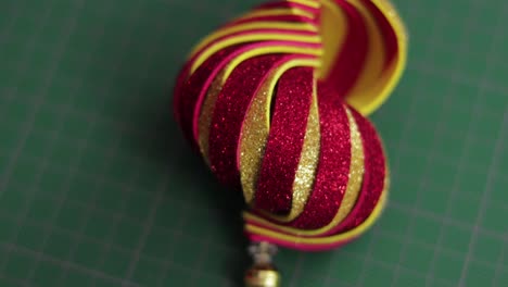 Red-and-gold-glitter-foami-christmas-ornament-on-green-cutting-mat