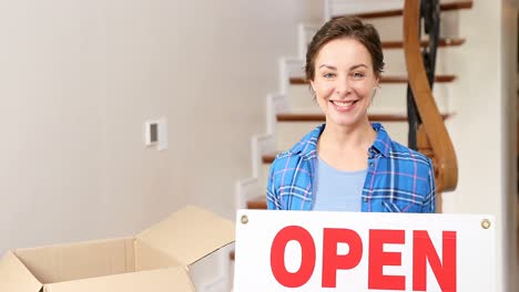 Smiling-young-woman-holding-sign-board-in-her-hands-4K-4k