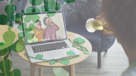 multiple clover leaves against woman drinking beer while having a video call on laptop at a bar