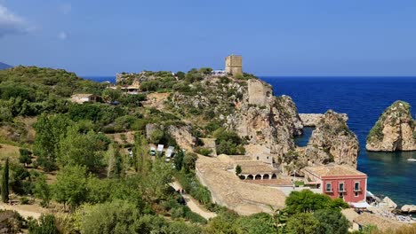 stunning panning panoramic view of stacks or faraglioni of scopello with tonnara tuna factory and torre doria tower in sicily