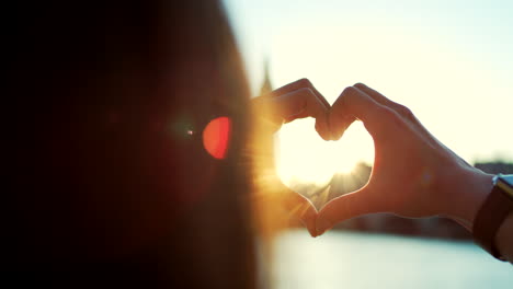 a woman creating a heart shape with her hands