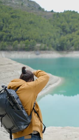 photographer capturing scenic lake and mountain landscape