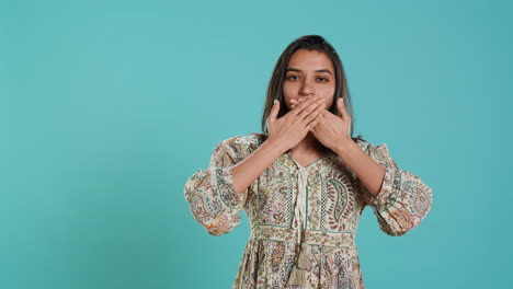 woman covering eyes, ears and mouth, imitating three wise monkeys