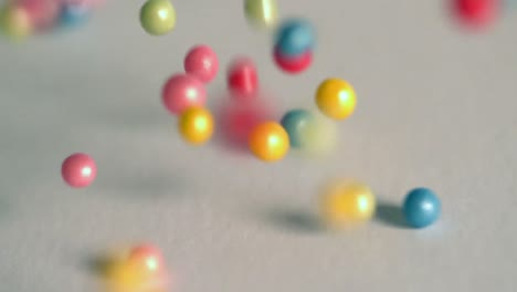 sugar balls falling onto grey surface