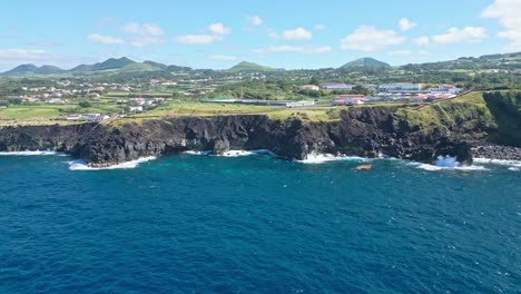 rocky cliffs and blue ocean waves near mosteiros village, são miguel, portugal, aerial view