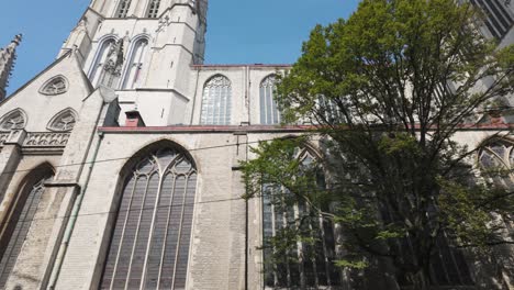 a towering gothic cathedral with arched windows, saint bavo's cathedral, ghent