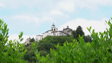 a view from the distance of the sacred mountain of varallo, a christian devotional complex, a unesco world heritage si in italy