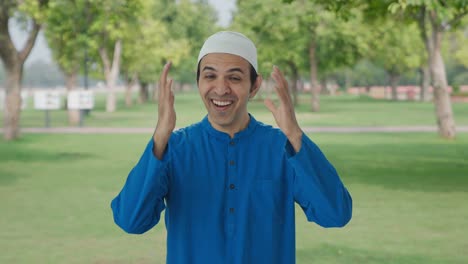 happy muslim man laughing on camera in park