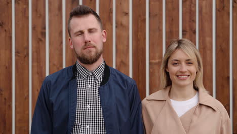 couple portrait in front of wooden wall