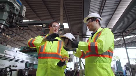 Factory-worker-warn-coworker-about-safety-and-give-hardhat-to-him