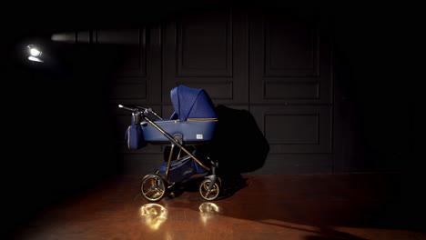 stylish blue baby stroller in a dark studio