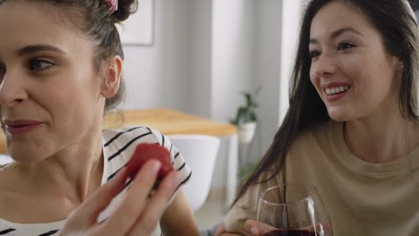 Tracking-video-of-three-friends-eating-strawberries-and-drinking-wine