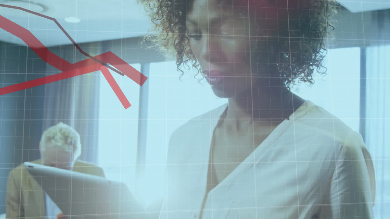 A businesswoman is using a digital tablet in her office, looking at global financial statistics