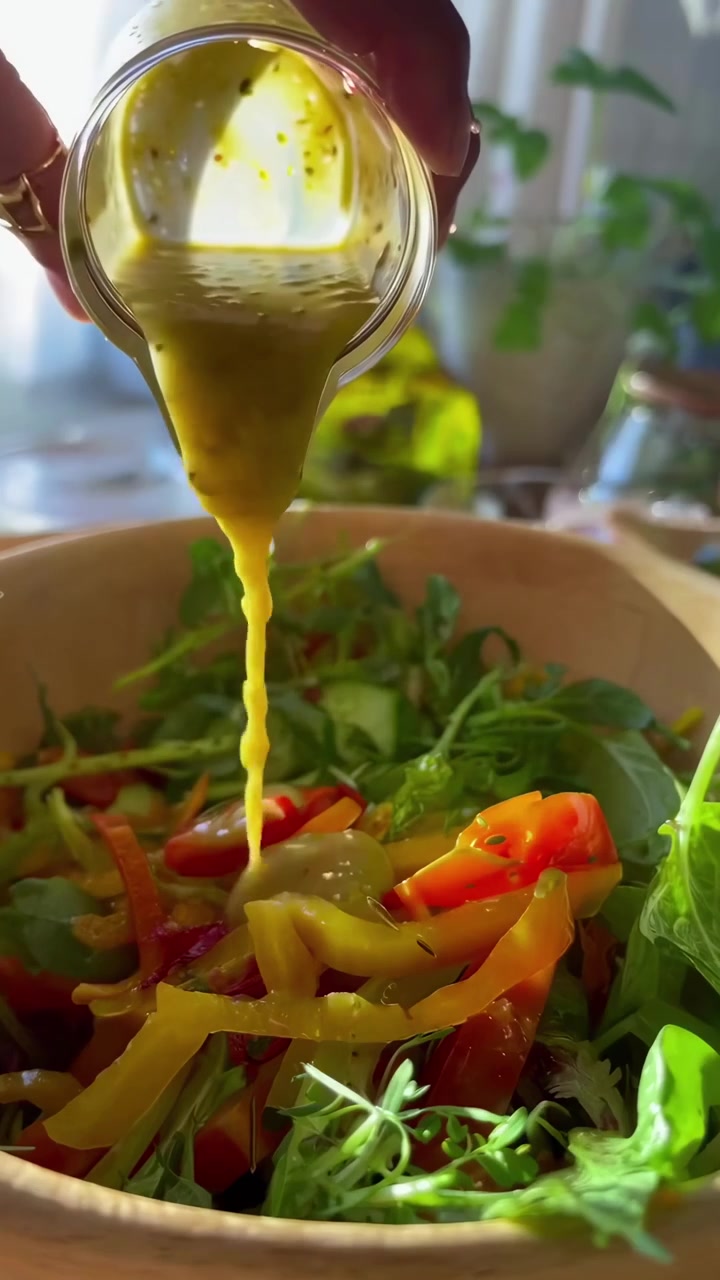 Person Preparing Fresh Vegetable Salad in a Wooden Bowl
