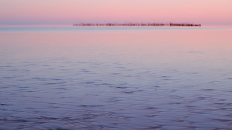 timelapse of tide coming in at daybreak