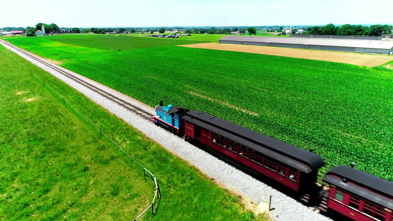 Thomas the Train Steam Locomotive in Amish Countryside on a Sunny Summer Day as seen by a Drone