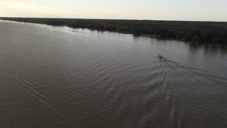 collective bus boat sailing along paraná river in delta area, argentina