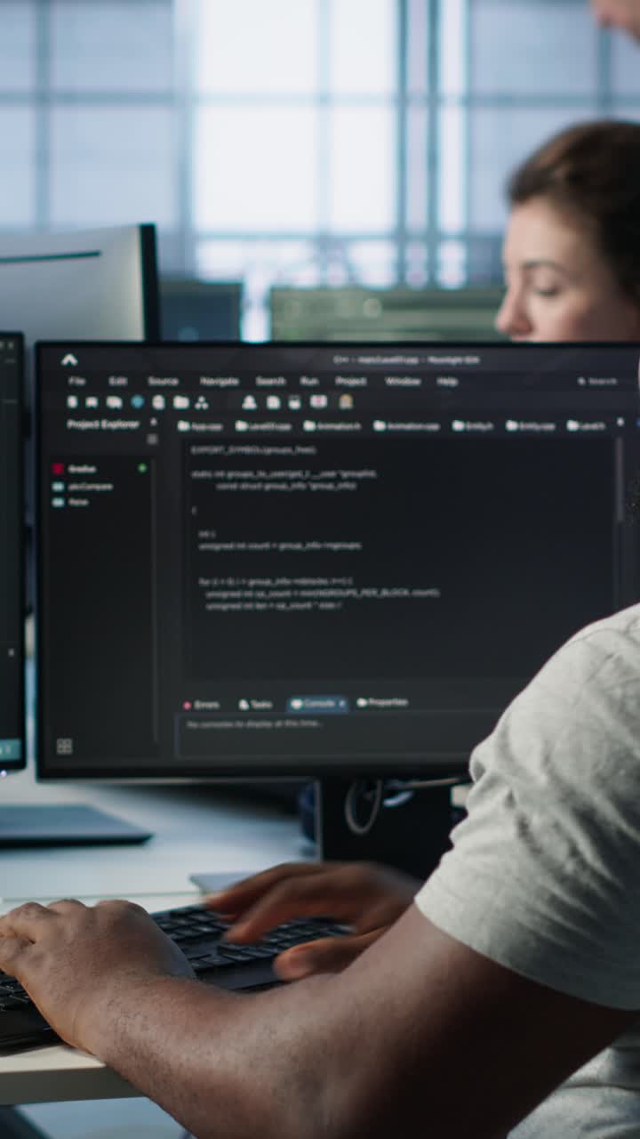 African American Man Typing Code on Computer in Office