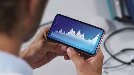 hands of caucasian man using smartphone with statistics on screen