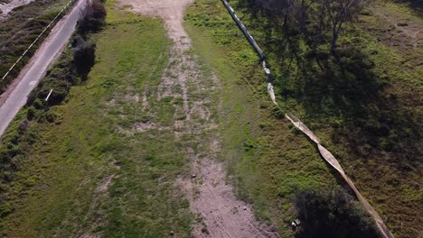 rise up aerial view over the site of the old quinns rocks campsite showing tyre tracks