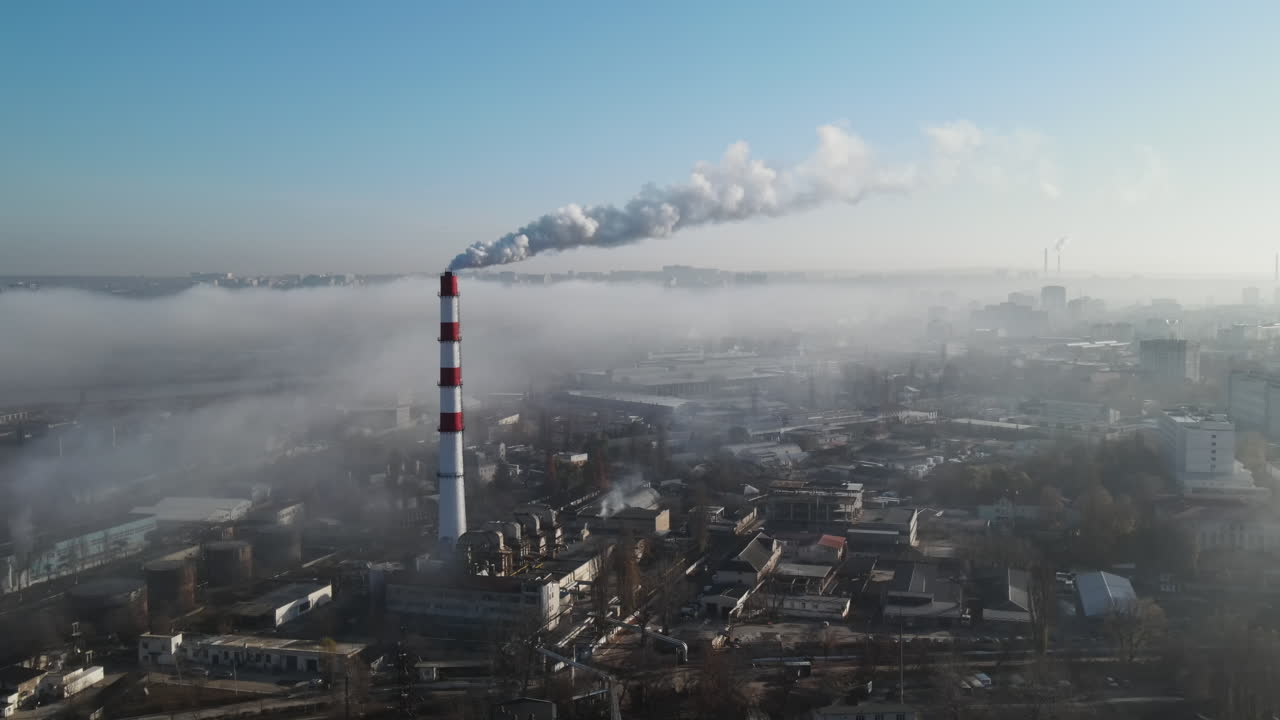 Aerial drone view of industrial smoke coming from pipe factory tube. City pollution idea