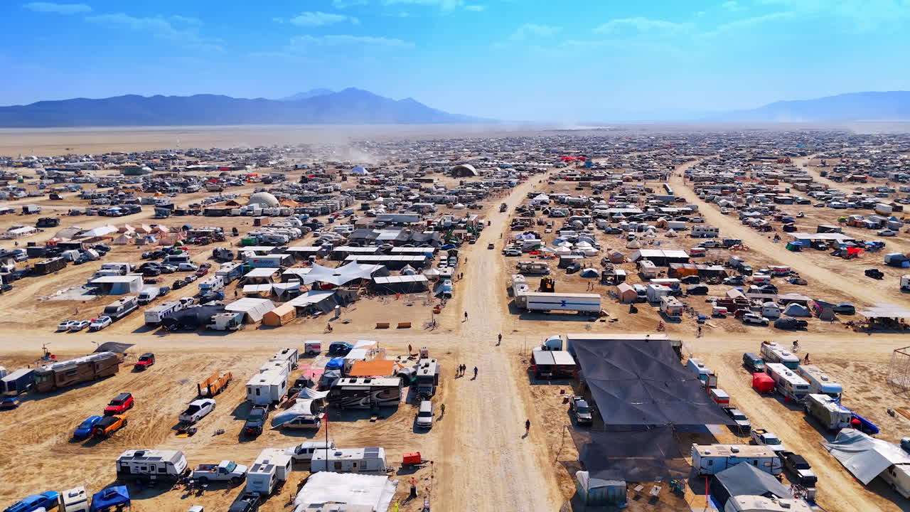 Nevada, USA, 14 August 2025: Wide aerial view of Burning Man camp and playa in Nevada desert.. Aerial perspective captures a large camp with roads and RVs