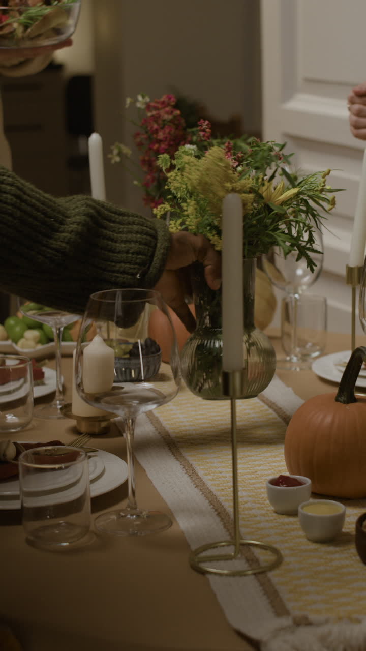 Festive Holiday Dinner Table Setting with Flowers and Pumpkin