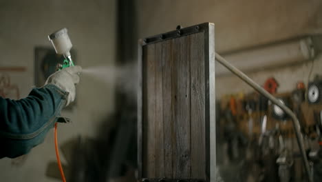 spray painting wooden furniture in a workshop