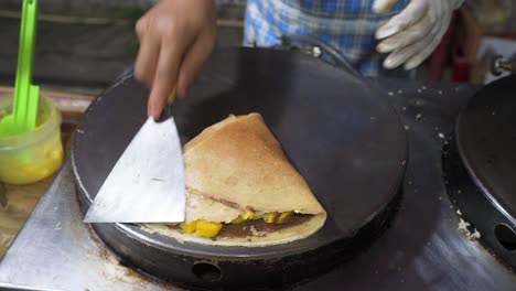 a close up shot of a man prepares delicious pancakes in the kitchen in the morning