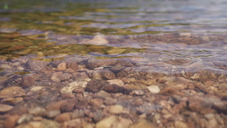 rocks are visible below the clear water of a river