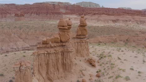 aerial drone flight around stone hoodoos guarding the valley of the goblins state park in utah, usa