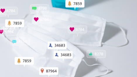 White mask lying flat on surface, translucent social media notification icons floating above