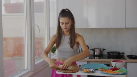 young woman preparing fresh spring rolls in a modern kitchen
