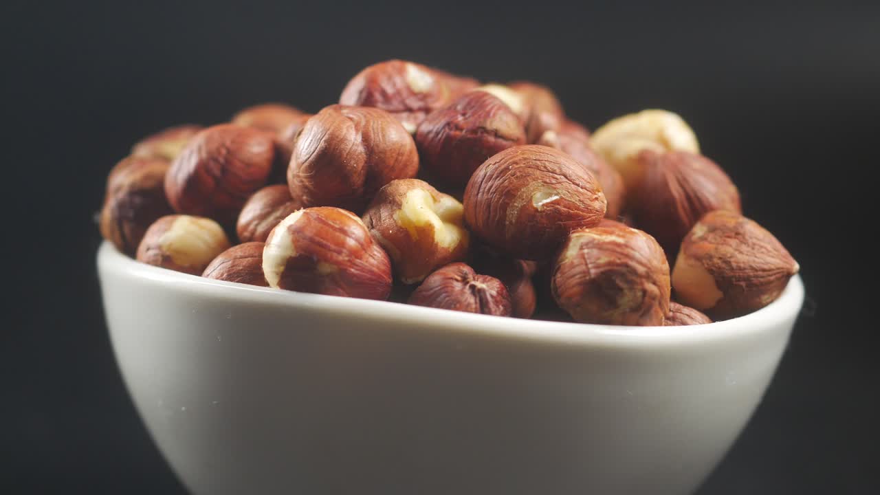 Close-up of hazelnuts in a white bowl