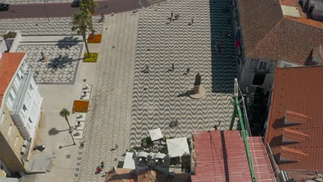 Topdown-view-along-Cascais-cidadela-square,-traditional-Portuguese-sidewalk-pattern