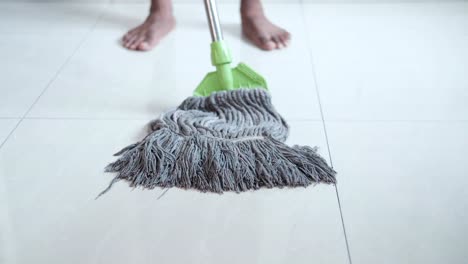 person mopping a tile floor