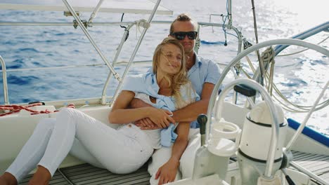 happy couple sailing on yacht