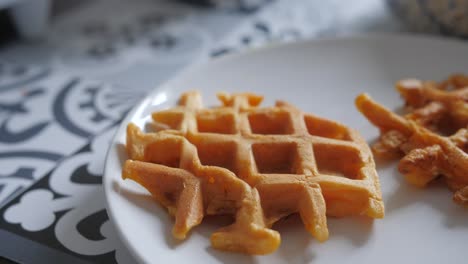 freshly cooked sweet potato waffles in ceramic plate