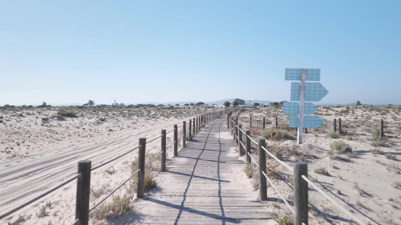Scenic boardwalk through sandy dunes on Ilha da Armona Olhão Portugal